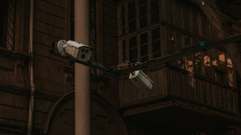 Street security cameras mounted on a pole in an urban environment, highlighting surveillance.